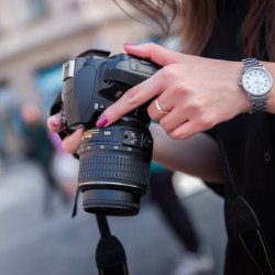 woman-holding-black-dslr-camera-167832